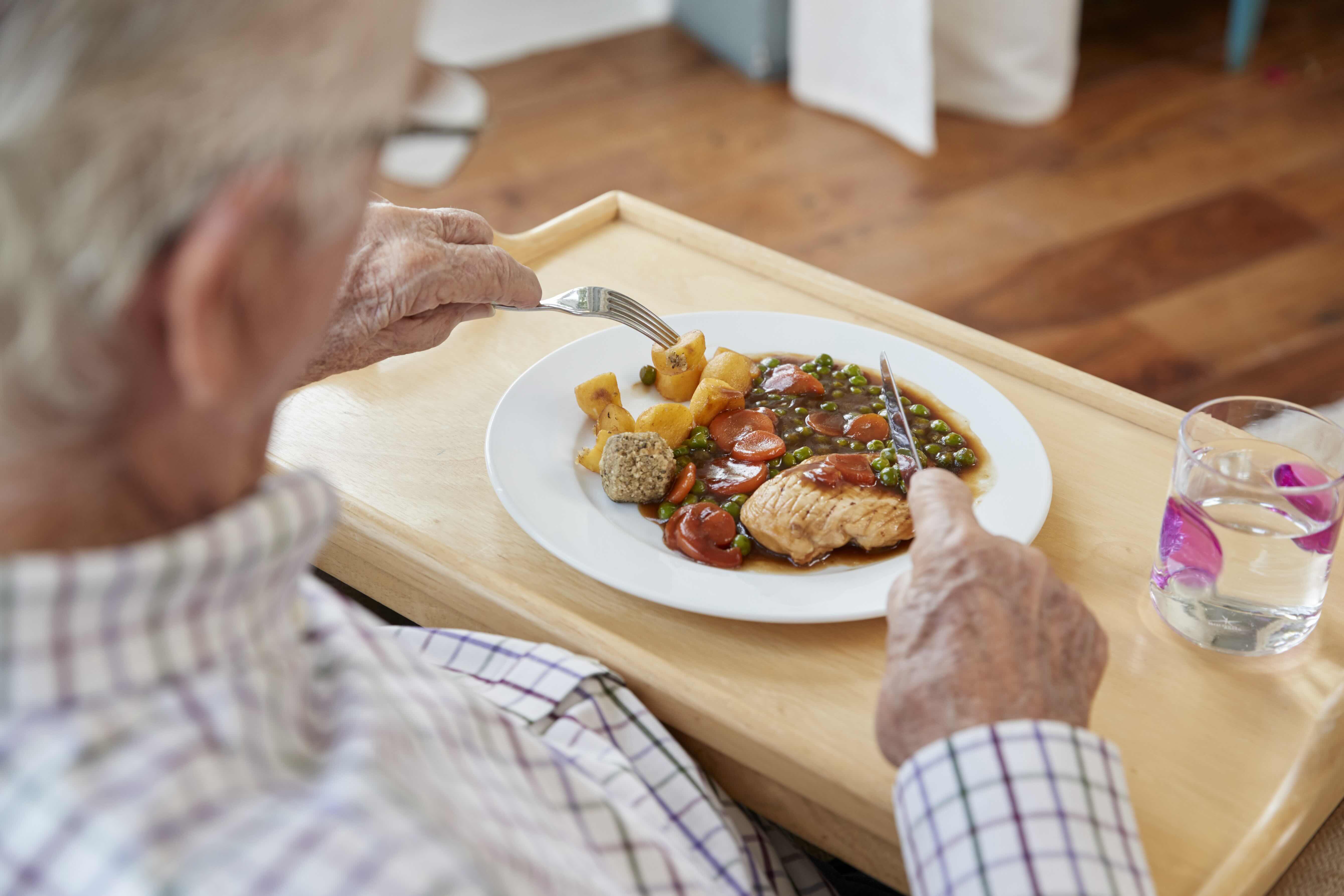 Over Shoulder View Of Senior Man Eating Dinner At 2024 10 21 16 19 59 Utc